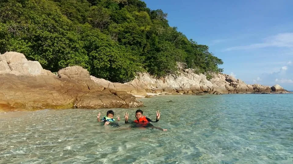 Beachfront chalet and boat scenes at Cocohut Long Beach Resort, Pulau Perhentian, with tropical sea and snorkeling activity highlights